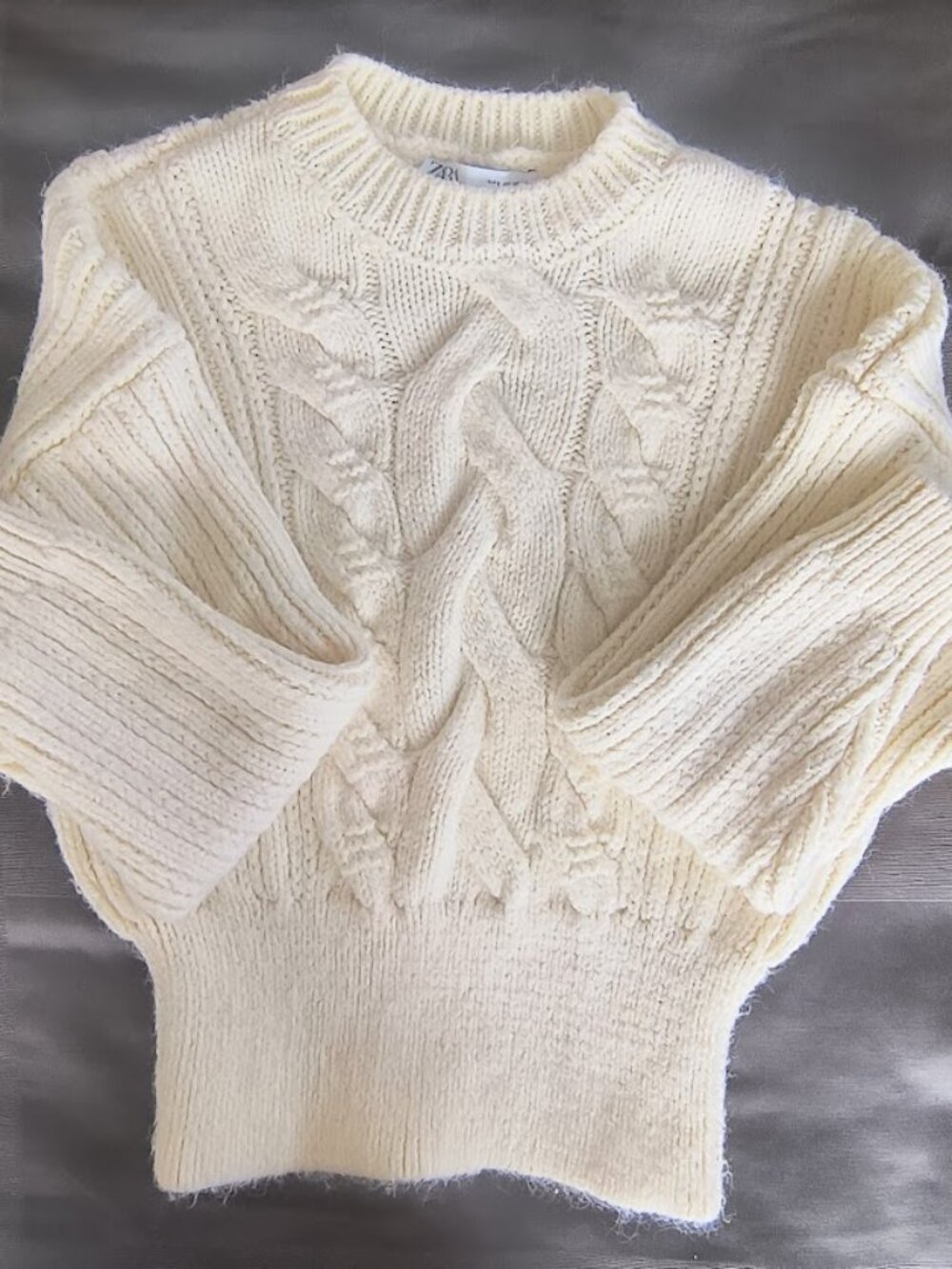 Zara cream-colored, thick cable-knit sweater with a ribbed hem